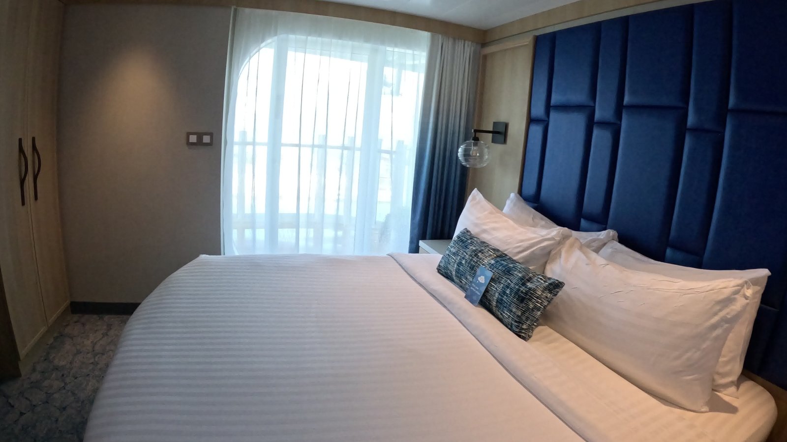 Bed and private balcony aboard Celebrity Ascent